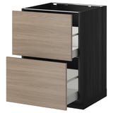 Unité de cuisine moderne noire avec 2 tiroirs brun clair partiellement retirés.