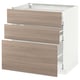 Cette image représente une armoire de cuisine METOD blanche avec trois tiroirs en grain de bois clair. Le design des tiroirs à fermeture automatique et une esthétique simple et moderne.