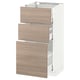 Un meuble de cuisine METOD blanc et marron clair avec trois tiroirs ouverts. L’armoire a un design moderne et épuré avec des tiroirs qui fonctionnent en douceur.