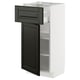 Armoire de cuisine blanche moderne avec tiroir et porte noirs, design élégant.