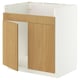 Un meuble de cuisine en bois blanc et clair avec une porte ouverte. Il combine un design moderne et des matériaux naturels pour un look élégant et fonctionnel.