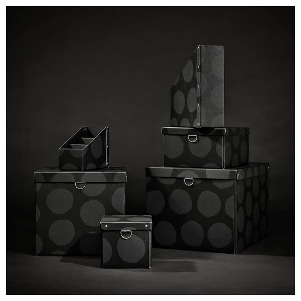 Boîtes de rangement NIMM noires, motif rond, empilées en différentes tailles, matériau en carton solide.