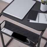 Bureau avec ordinateur portable, ordinateurs portables et recharge de téléphone. La table a une étagère inférieure avec télécommande et câble.