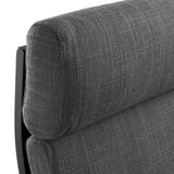 Un coin d’une chaise rembourrée gris foncé avec un dossier robuste et incurvé, mettant en valeur sa conception durable, confortable et de soutien.