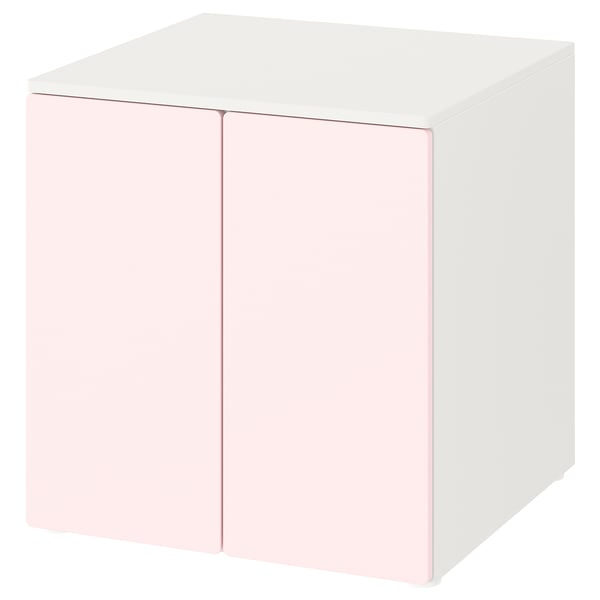 Un meuble de rangement cubique SMÅSTAD blanc et rose clair avec des portes à fermeture douce.