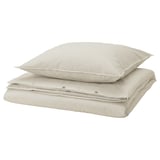 Deux coussins rayés beige et blanc, empilés.