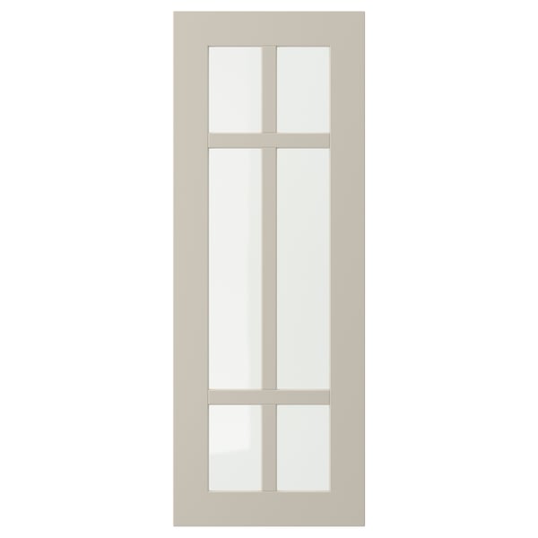 Une porte d’armoire STENSUND beige avec un design en verre quadrillé.