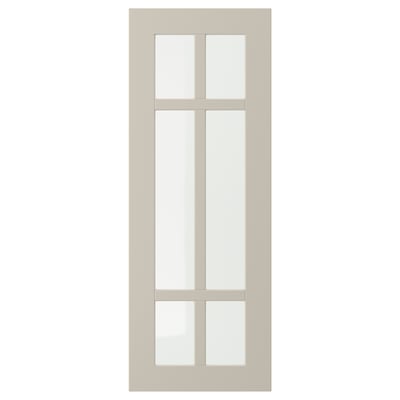 Une porte d’armoire STENSUND beige avec un design en verre quadrillé.