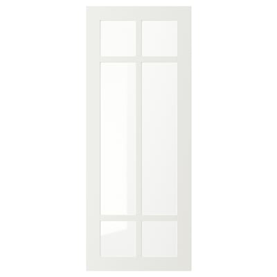 Une porte d’armoire STENSUND blanche avec un panneau en verre dépoli. Il a une forme rectangulaire avec un design élégant et moderne, adapté aux armoires de cuisine.