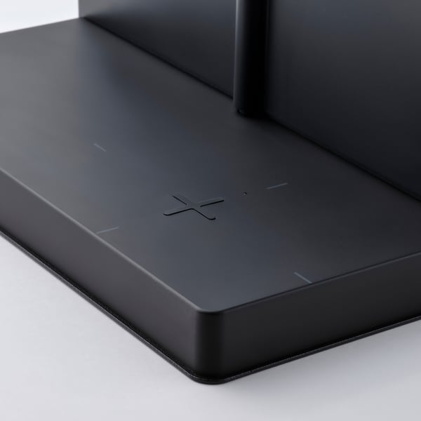 Étagère noire minimaliste avec chargeur sans fil, design sans couture et moderne.