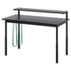 Bureau de jeu UTVISNING noir avec hauteur réglable, étagère de moniteur et sangles de câble vertes, conçu pour les espaces compacts.