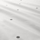 Points noirs sur matière légère. Texture douce et uniforme avec fermeture éclair.