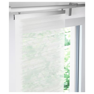 Un rideau semi-transparent est suspendu à une tringle à rideaux blanche, laissant passer la lumière du jour filtrée, ce qui est idéal pour les solutions de fenêtres superposées.