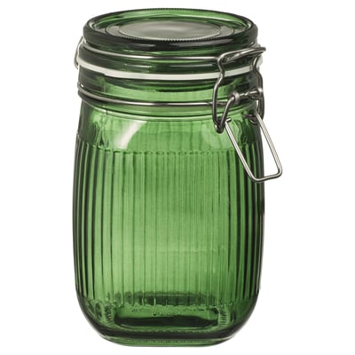 Pot en verre vert avec couvercle fermoir en métal, design nervuré. Compact, forme cylindrique, joint étanche à l’air.