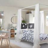 Studio moderne avec lit VITARNA, literie bleue, bureau, chaises roses.