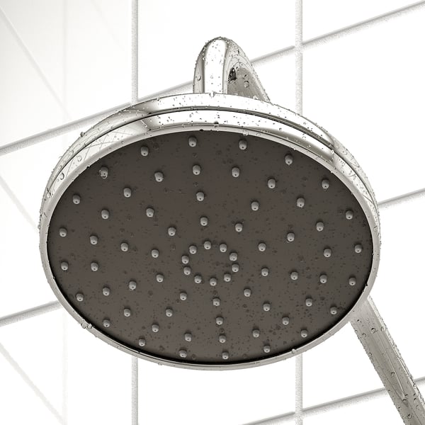 Pomme de douche avec plusieurs buses pour un jet complet, montée sur un mur carrelé.