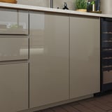 Armoires de cuisine modernes avec finition gris-brun foncé brillante. Poignées élégantes et intégrées et surfaces lisses.