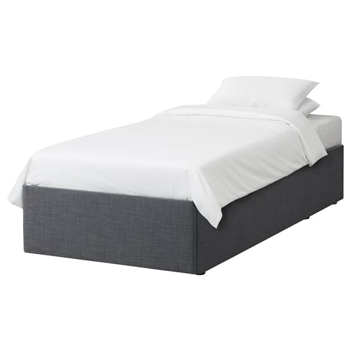 Grey BALESTRAND bed with white sheets, drawer storage, minimalist design.