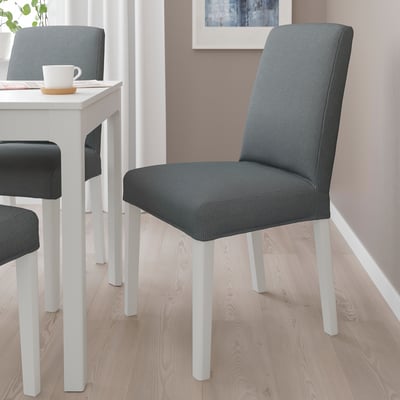 Grey BERGMUND dining chair with white legs in modern kitchen.