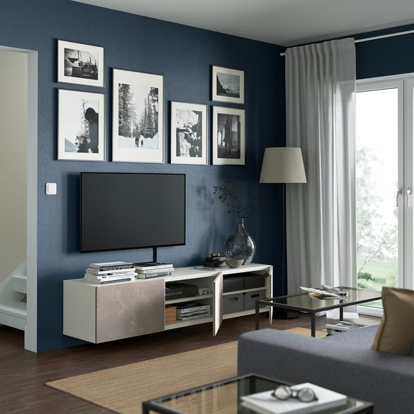 Modern living room with tv, lamp, table, and large window.