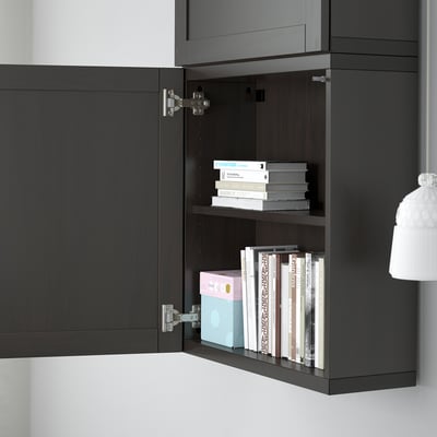 Black cabinet with open door revealing adjustable shelves filled with books.