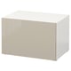 A white BESTÅ storage unit with a glossy beige door, rectangular shape, and flat design. Made from particleboard, plastic foil, and fiberboard.