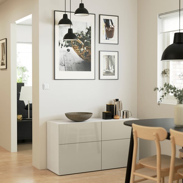 Modern dining area with BESTÅ sideboard, three drawers, adjustable shelves, and decorative items.