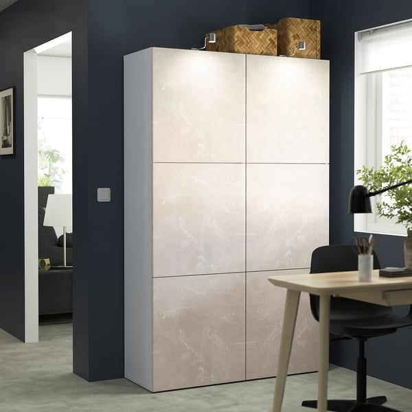 Beige BESTÅ storage unit with 6 doors against dark wall.