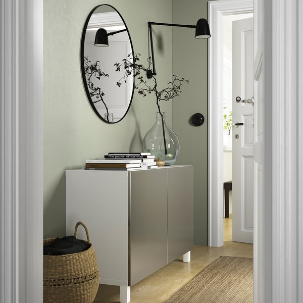 Modern entryway with white BESTÅ sideboard, mirror, basket, soft-close doors.