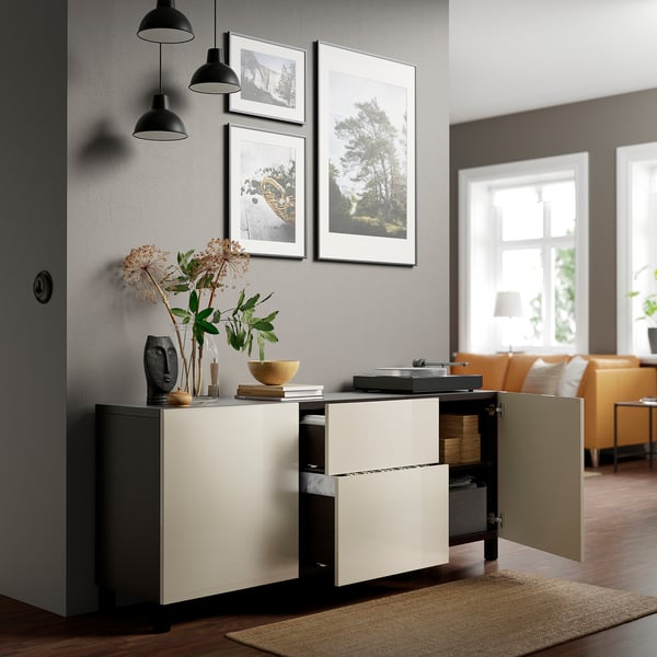 Modern living room with open BESTÅ sideboard; displays records, flowers, and art; adjustable hinges visible.