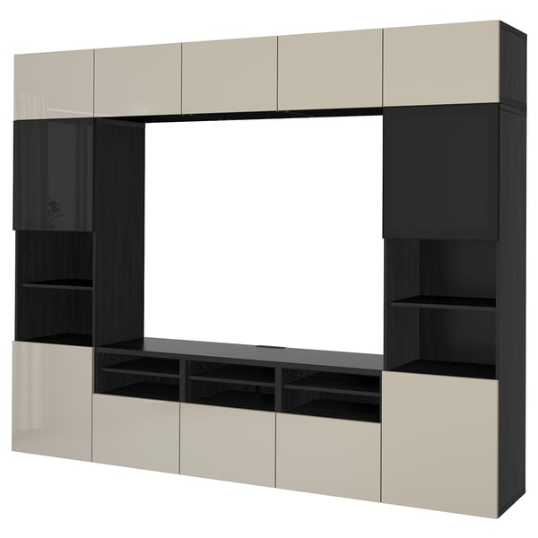 Modern BESTÅ tv unit with beige and black cabinets. Offers ample storage with shelves and adjustable compartments, ideal for media setup.
