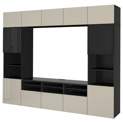 Modern BESTÅ tv unit with beige and black cabinets. Offers ample storage with shelves and adjustable compartments, ideal for media setup.