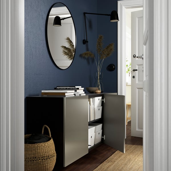Modern wall-mounted cabinet with mirror, books, and flowers. Reflects clean, airy look with open storage.