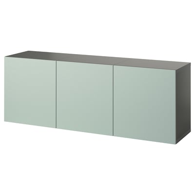 A wall-mounted, light green, rectangular BESTÅ storage unit with three doors and a sleek, minimalist design.