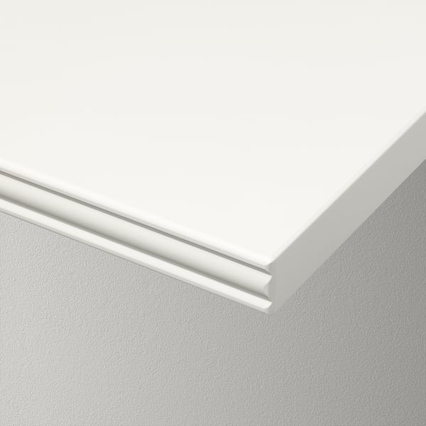 Close-up of smooth, white furniture corner showing clean, precise edges and sleek design.