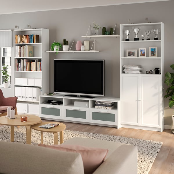 Modern living room: BILLY tv unit, bookshelves, flat-screen tv, plants, and colourful accents.