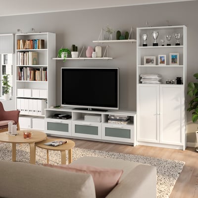 Modern living room: BILLY tv unit, bookshelves, flat-screen tv, plants, and colourful accents.