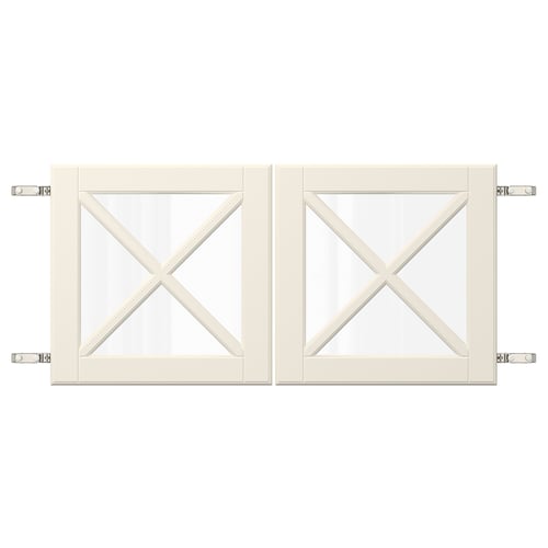 Two white cabinet doors with glass panels featuring an x-crossbar design, attached by metal hinges.