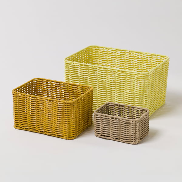 Three woven baskets of varying sizes. Yellow colours, rectangular shape. Smallest at front, larger ones behind.