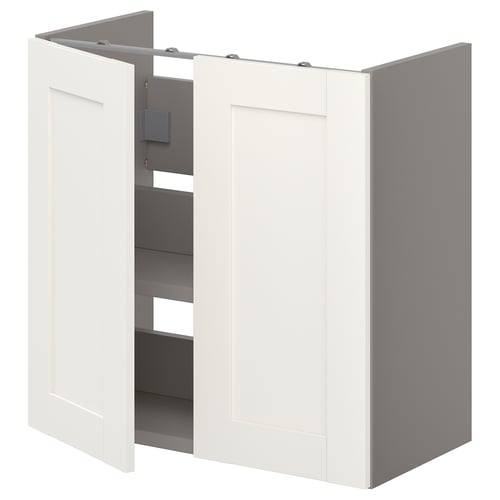 An ENHET white bathroom cabinet with open doors, revealing storage shelves.