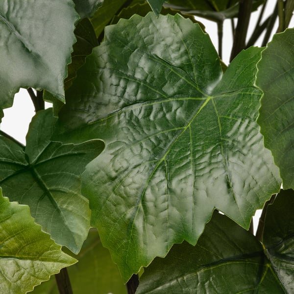 Artificial plant leaves, vivid green, textured detailing, lifelike appearance.