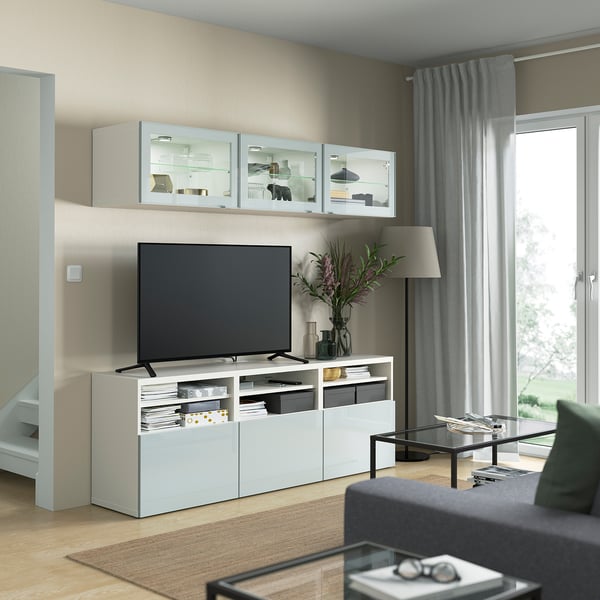 Modern living room with GLASSVIK glass cabinet and selsvik tv stand. Minimalist design with decor, lamp, and coffee table.