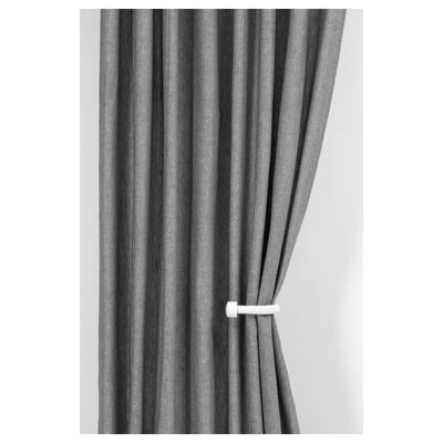 Grey curtains held back with white tiebacks.