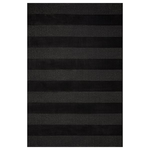 Dark grey rug with curly yarn stripes for large spaces, made from recycled materials.