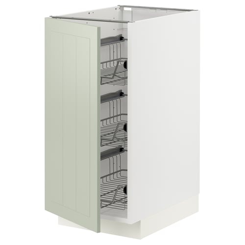 A METOD kitchen cabinet in green with organised interior shelves.