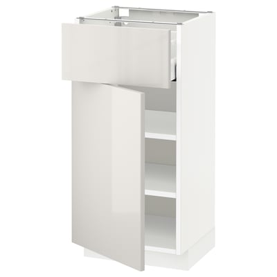 White high-gloss kitchen cabinet with top drawer and shelf.