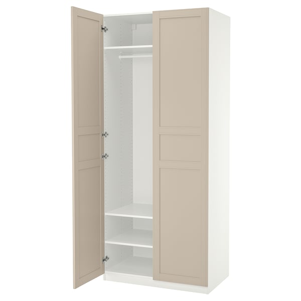 An open beige and white PAX wardrobe with one door, showcasing shelves and a hanging rod.