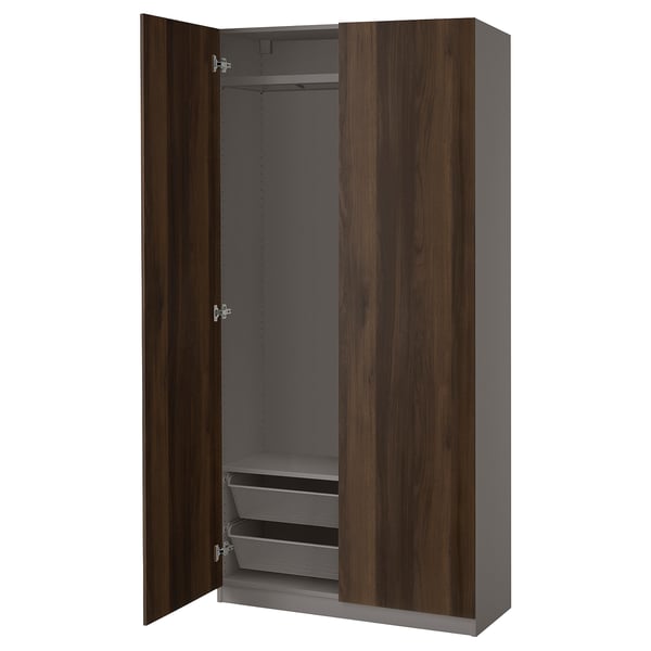 Dark wood-finished PAX wardrobe open, featuring shelves and hanging space.