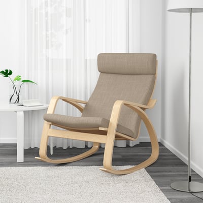Light, natural wooden rocking chair with a beige cushion on a cosy rug.