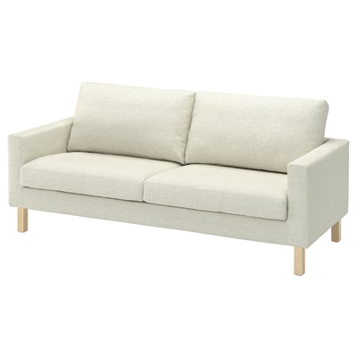 Light-colored sofa with minimalist design, wooden legs, light fabric.